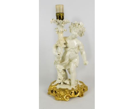 A Moore Bros figural lamp base of a child with gilt painted scrolling base, height excluding fitment 34cm (af). CONDITION REP
