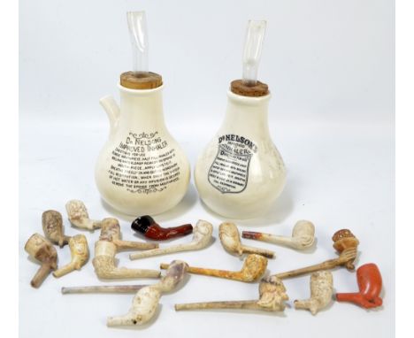 A small quantity of clay pipes of varied size and form to include examples with figural bowls, stems modelled as arms and han