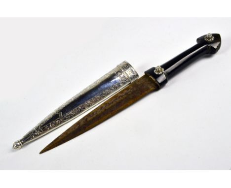 A late 19th/early 20th century Eastern horn handled kindjal dagger with white metal shafted scabbard engraved with bands of f