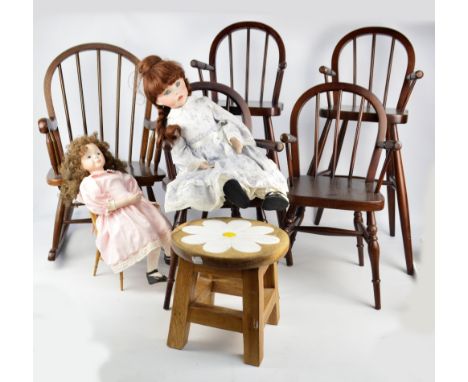 A group of mahogany doll's furniture comprising a pair of high chairs with spindle backs, a rocking chair and two further arm