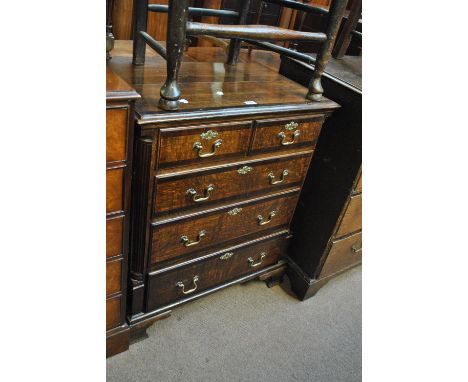 A small George III oak and mahogany crossbanded chest of two short and three long drawers on ogee bracket feet, width 78cm.
