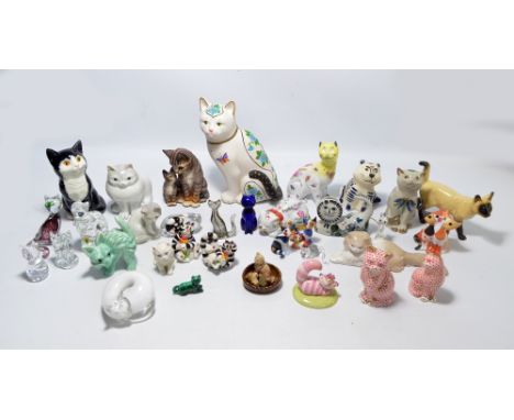 A collection of over twenty ceramic model cats of varied size and form to include Royal Doulton Cheshire Cat, realistic and s