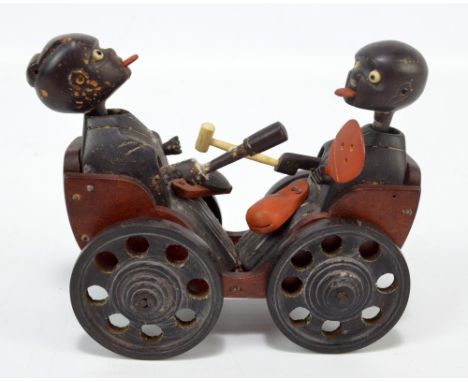 A Japanese Meiji/early Showa period Kobe wooden articulated toy modelled as two stylised musicians with elongated necks ridin