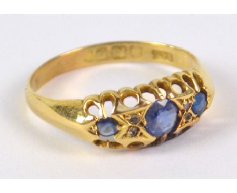 An 18ct yellow gold ring, set with three graduated sapphires (one replaced with glass), size Q, approx 2.5g.