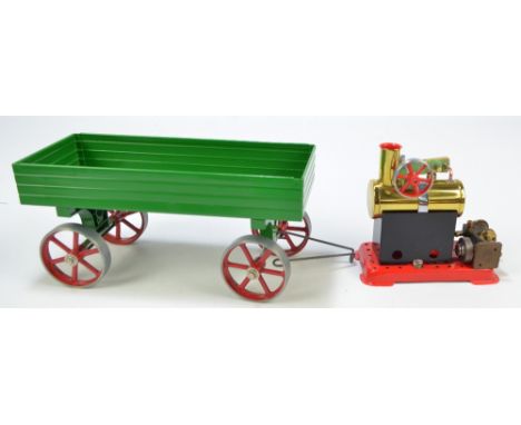 A Mamod Stationary Steam Engine (lacking box and accessories) and a trailer in green livery (unboxed) (2). CONDITION REPORT: 