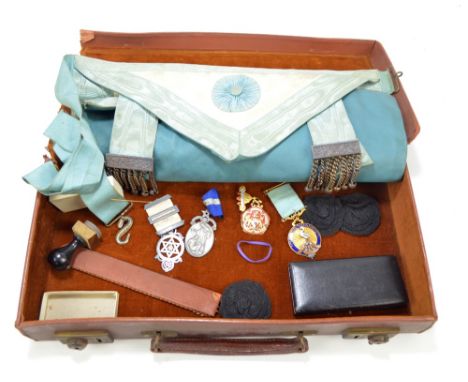 A small collection of Masonic items comprising apron, four jewels including two hallmarked silver examples and a stamp/seal, 