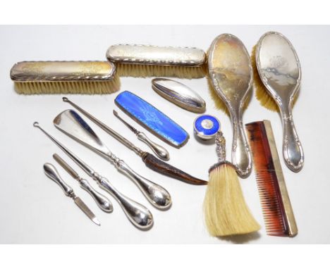 A quantity of hallmarked silver dressing table and manicure items comprising a pair of clothes brushes with ribbon and flower