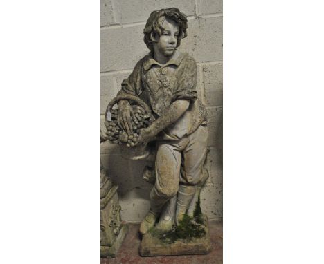A well modelled composite garden statue modelled as a young boy with a basket of grapes leaning against a tree trunk, on rect