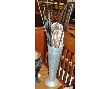 Equestrian interest; a metal stick stand containing a collection of varying whips and crops, some (af).