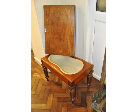 A 19th century mahogany bidet, the rectangular top enclosing an enamel liner, on turned supports, 58.5 x 37cm.