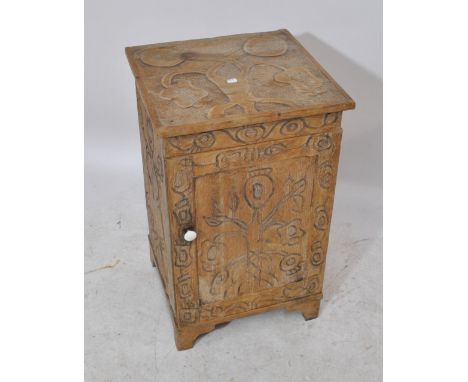 A square topped pine cupboard enclosing single drawer with highly stylised carved floral decoration, on bracket feet, height 