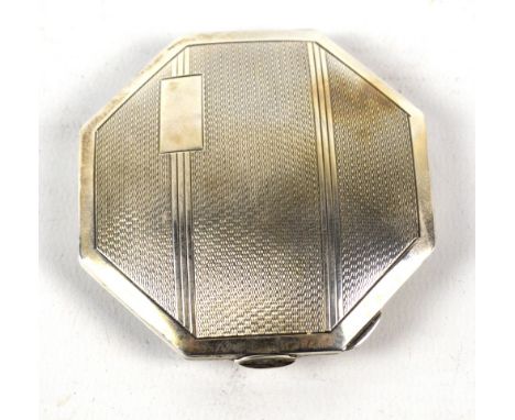 WILLIAM ADAMS LTD; a George V hallmarked silver octagonal compact with engine turned decoration and initials 'A' to the recta