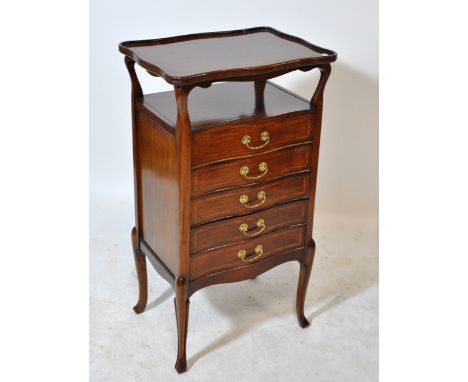 An Edwardian mahogany and inlaid bowfronted music cabinet with dished shaped rectangular top above shelf and five drawers on 