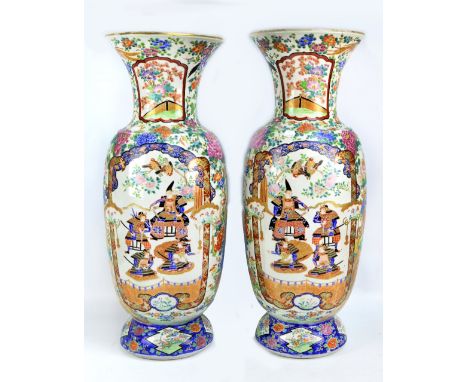 A pair of large 19th century Chinese porcelain Famille Rose opposing baluster vases painted in enamels with two opposing pane