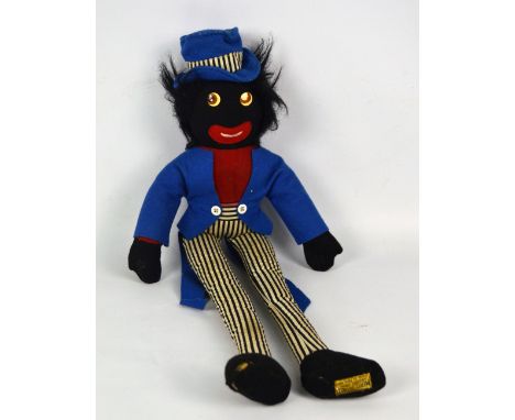 A Merrythought Golly doll in blue coat and hat with pinstripe trousers, stitched manufacturer's label to bottom of left foot,