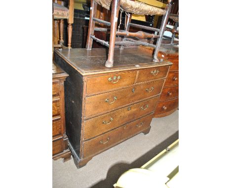 A Georgian oak chest of two short above three long drawers, on ogee bracket feet, width 100cm, height 97cm (top af).