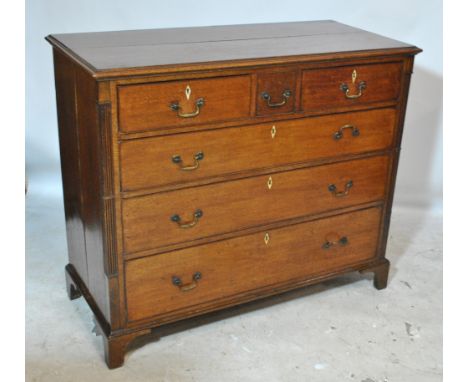 A late George III oak chest of three short and three long graduated drawers with fluted pilasters and bracket feet, width 124