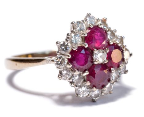 An 18ct white gold and platinum diamond and ruby cluster ring, the raised central platform with three round rubies, approx 1.