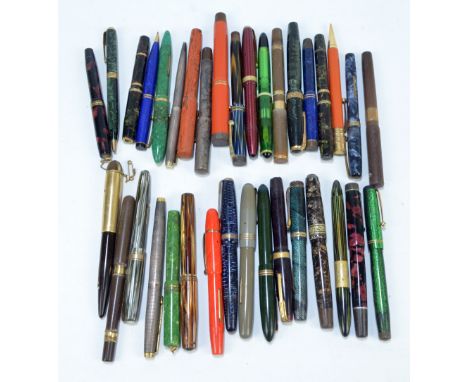 A collection of thirty-five vintage fountain pens, ballpoint pens and pencils, including marbled and horizontally striped exa