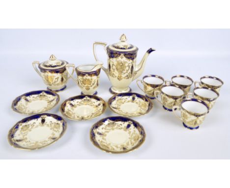 A Noritake six setting coffee set decorated with gilt floral and foliate motifs on a blue and cream ground, comprising cups, 