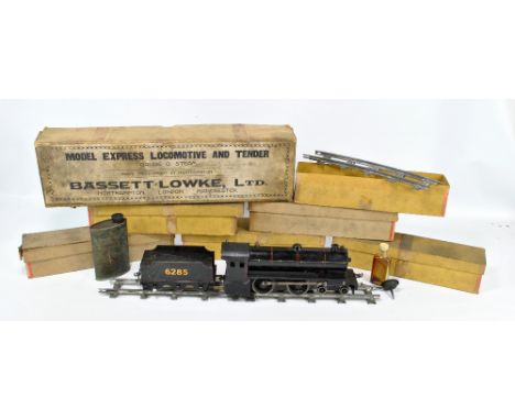 A boxed Bassett-Lowke model express locomotive and tender, both in black with red detail, the tender numbered 6285, length of