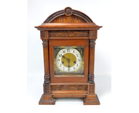 JUNGHANS; a circa 1900 German stained beech eight day chiming mantel clock, the domed top above rectangular brass dial with s