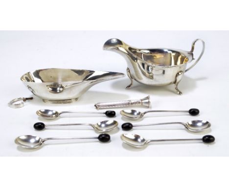 A small group of variously hallmarked silver items comprising a sauce boat with shaped rim, Viner's Ltd, Sheffield, date lett