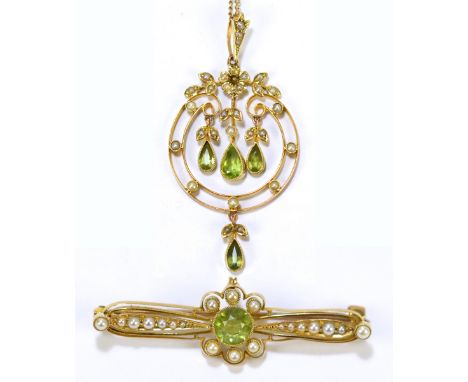 An Edwardian Art Nouveau yellow metal green peridot and cultured pearl pendant suspended on a fine link chain, and a near mat