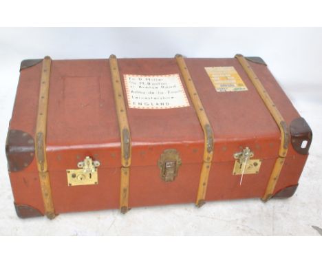 A mid-20th century leather and wooden bound trunk.