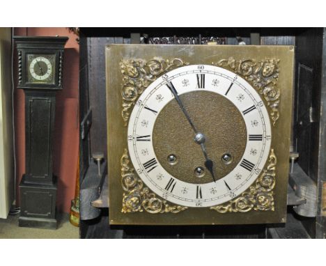 An early 20th century oak longcase clock of small proportions, the silvered chapter ring set with Arabic and Roman numerals a