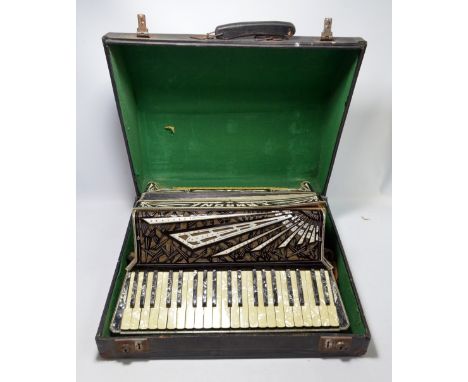 A cased Camroni piano accordion, with black and simulated mother of pearl marbled Art Deco effect.