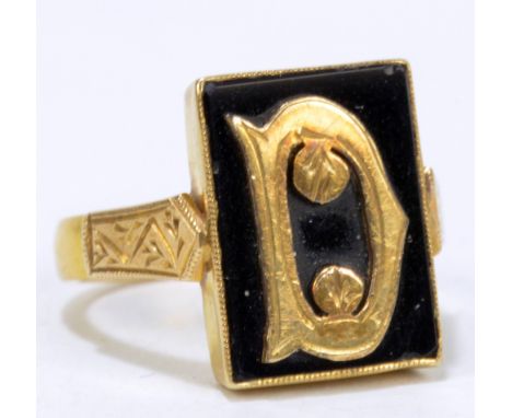 A 22ct yellow gold and black ring with engraved detail to the shoulders, size L, approx 5.5g.