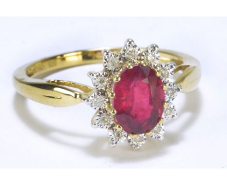 A 9ct yellow gold oval ruby and diamond floral set ring, size R, approx 2.7g.