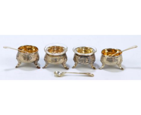 A set of four late 19th century probably Italian open circular salts with engine turned decoration and vacant oval cartouches