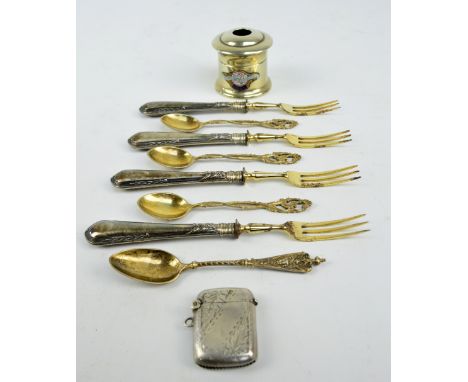 A set of four late 19th century German 800 grade silver handled dessert forks and a part set of three further gilt 800 grade 