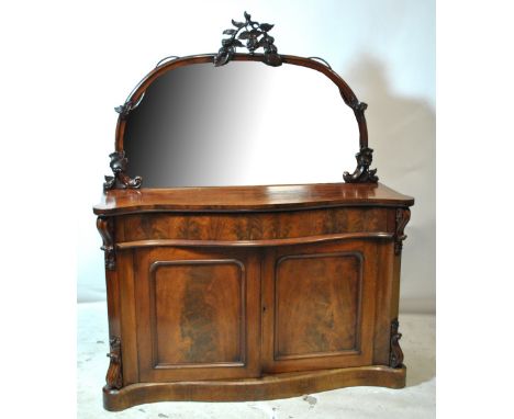 A Victorian mahogany serpentine front mirror back chiffonier with twin cupboard doors to front enclosing single shelf above t