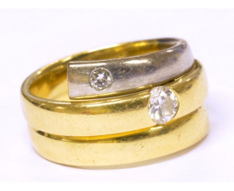 An 18ct two-tone gold two stone diamond ring, with central band set with round brilliant cut stone weighing approx 0.20cts, w