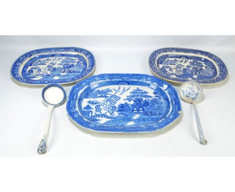 Three 19th century willow pattern decorated oval platters in various sizes, the largest 48 x 36cm and two blue and white tran