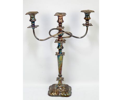 A large electroplated candelabrum with entwined twin branches and central sconce above tapering and cast decorated stem on sh