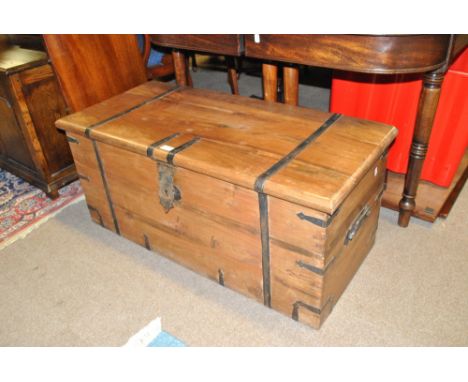 A 20th century hardwood strap bound trunk, width 102cm.