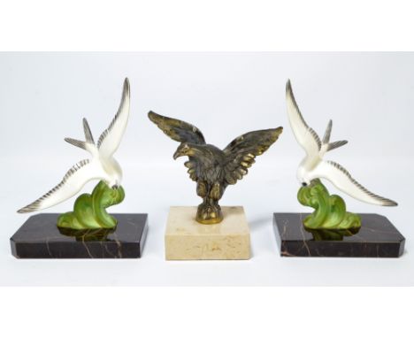 A pair of Art Deco style French painted spelter bookends modelled as birds, height 19cm and a further bird ornament on square