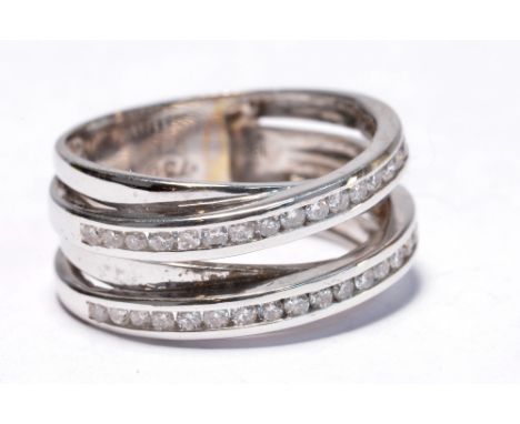 An 18ct white gold and diamond ring, the small diamonds channel set into two crossover bands, size N, approx 7.3g.