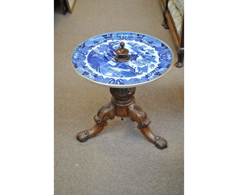 A Victorian walnut tripod occasional table with porcelain 'Old Willow' pattern circular top to scroll carved base.