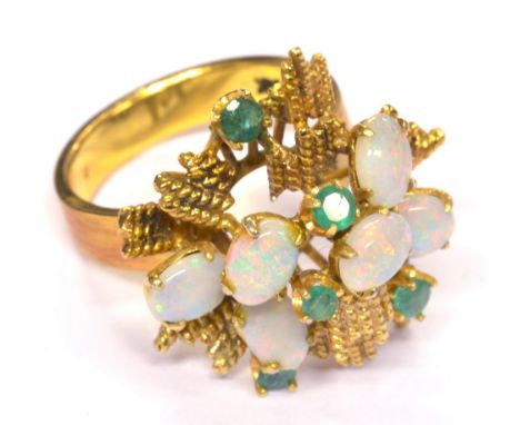 A 14ct yellow gold opal and emerald ring, in high stepped setting with six oval opals and five round emeralds, ring size O, a