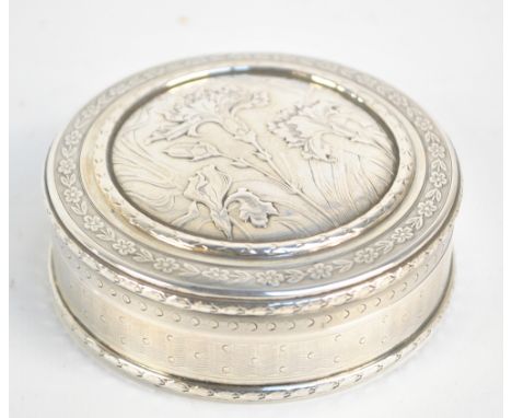 A late 19th century French silver Art Nouveau style circular box cast and engraved with floral motifs within husk border to t