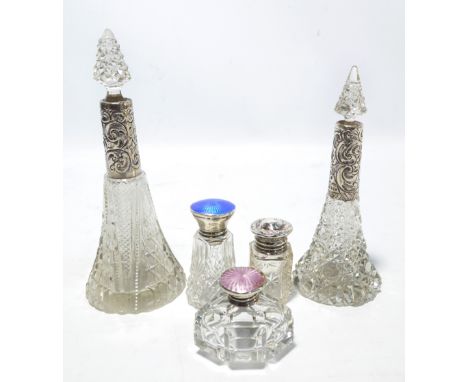 Five variously hallmarked silver mounted clear cut glass scent bottles to include a hobnail cut tapering example by John Haze