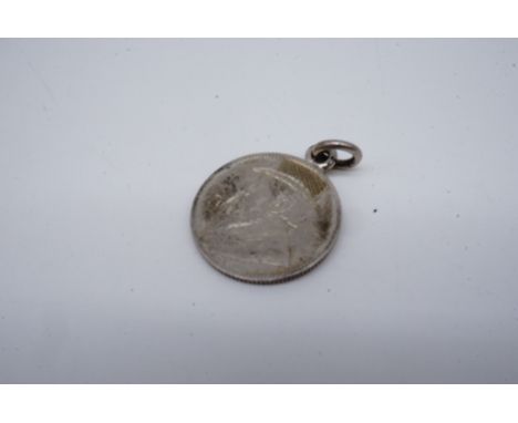 A Boer War ZAR coin converted to a watch chain fob medallion, the obverse profile bust of Paul Kruger engraved with a hat and