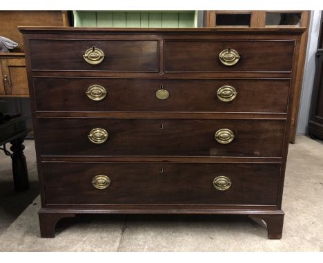 A fine George III mahogany chest of drawers, having oval stamped brass back-plate bale handles and square bracket feet, 50 cm