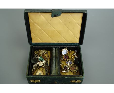 A late 19th / early 20th Century green leather jewellery box containing vintage jewellery including a Victorian silver "Eliza