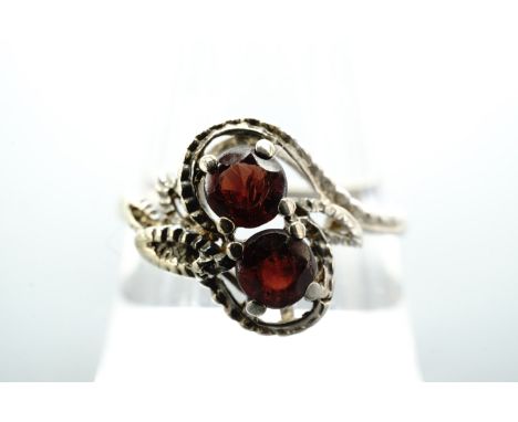 A twist-set red stone and 9 ct gold ring, the stones of approx, 5 mm within a beaded open-work and foliate setting, R, 1.9 g